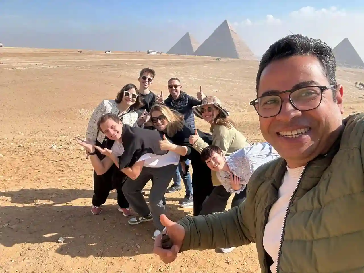 Cairo tour guide explaining the Pyramids of Giza to tourists
